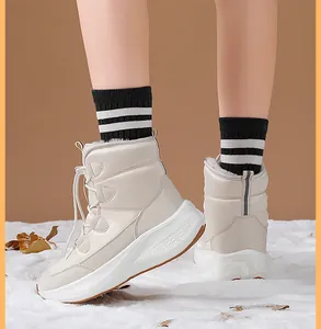 Close-up of beige winter snow boots featuring thick fleece lining and durable rubber soles