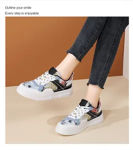 Dettaglio di sneaker con zeppa in pelle bianca e motivo artistico a inchiostro cinese