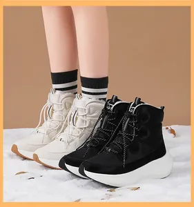 Detail of waterproof winter boots with drawstring laces and thick non-slip soles on snow