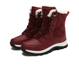 Detail view of burgundy snow boots with quilted finish and thick faux fur lining