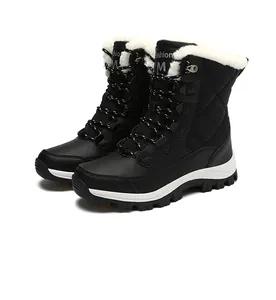 Detail showing thick faux shearling lining and lace-up design of black snow boots