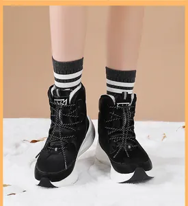 Detail of waterproof black winter snow boots with thick anti-slip rubber soles and warm lining