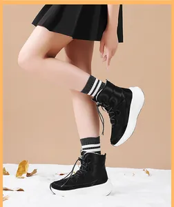 Detail of black quilted winter snow boots with white thick soles and warm lining