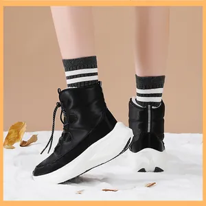 Close-up of black winter snow boots with warm fur lining and thick non-slip soles
