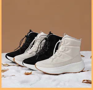 Close-up of black and beige thermal winter boots with waterproof nylon and faux fur lining