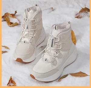 Close-up of beige winter snow boots with warm faux fur lining and drawstring closure