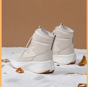 Close-up of quilted high-top snow boots featuring thick non-slip soles and warm faux fur lining