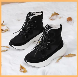 Close-up of black winter snow boots showing warm white faux fur lining and thick soles