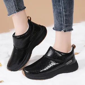 Women's black faux fur snow boots with textured snakeskin pattern and thick soles