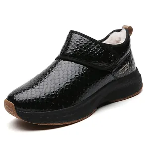 Black glossy faux leather snow boots with crocodile texture and warm plush lining