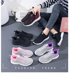 Detailed close-up showing breathable mesh material and lace-up design of women's sneakers