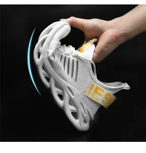 Close-up showing the flexible blade sole and breathable mesh fabric of white running shoes