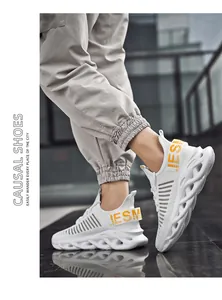 Detail of white mesh sneakers showing chunky hollowed-out soles and IESM logo detail