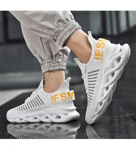 Detail of white mesh sneaker with hollow wave sole and yellow IESM heel pull tab