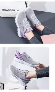 Close-up of lightweight grey breathable mesh sneakers with purple plaid interior details