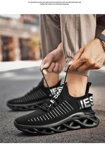 Close-up of black breathable knit sneakers for men with hollow wavy blade sole design