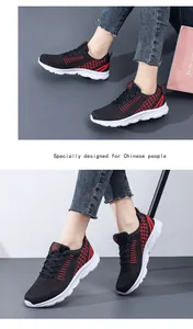 Detail of breathable mesh upper and red embroidery on black lightweight sneakers