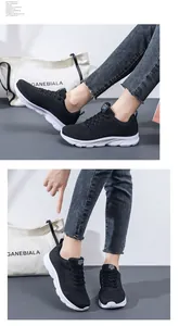 Detail of black breathable knit running sneakers with thick white soles for daily wear