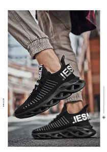 Outdoor macro shot of black breathable mesh sneaker featuring a hollow cushioning sole