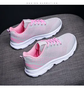 Detail view of breathable grey knit mesh running shoes with pink laces and cushioned sole
