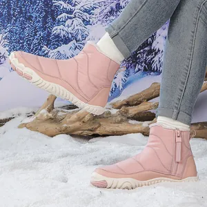 Pink waterproof snow boots for women with side zipper and warm faux fur lining