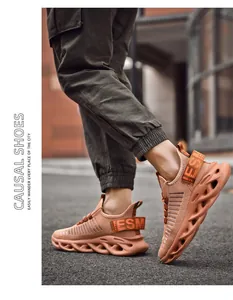 Close-up of orange men's mesh sneakers with unique wave-shaped hollow platform soles