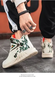 Detail of high-top men's sneakers featuring green camo pattern and chunky white soles