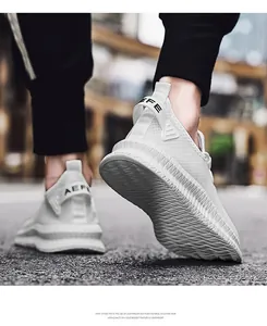 Detail shot of breathable flyknit sports sneakers with thick EVA sole in street setting