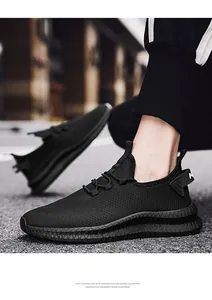 Detail of breathable mesh upper and lightweight EVA sole on black running shoes