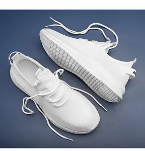 Macro shot of breathable white knit mesh texture and laces on fashion sneakers