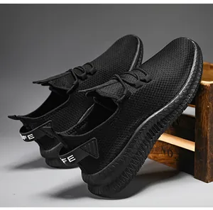 Detail view of black breathable mesh sneaker with thick sole and heel pull tab