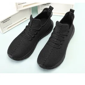 Detail of breathable black mesh upper and lace-up closure on men's running sneakers