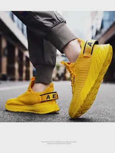 Detail of breathable yellow mesh upper and thick lightweight EVA foam sole on running shoes