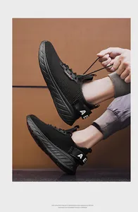 Detail of breathable mesh fabric and lightweight EVA sole on black athletic running shoes