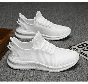 Close-up of white breathable mesh sneakers with non-slip rubber soles and heel pull tab