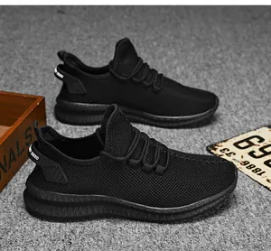 Detail of black breathable mesh sneaker with thick non-slip rubber sole and heel pull tab