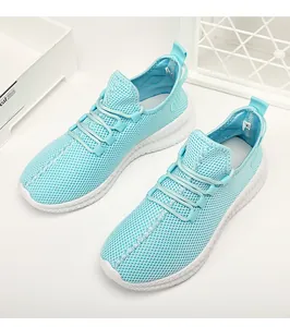 Close-up of light blue breathable mesh upper and white non-slip sole on women's sneaker
