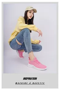 Detailed side view of pink mesh sneakers with thick white soles on a female model