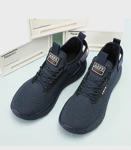Top-down detail of dark blue breathable mesh knit running shoes with thick cushioned soles
