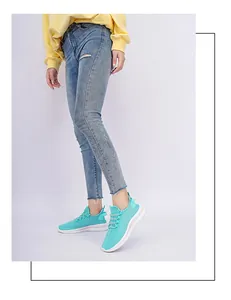 Side view of mint green mesh running sneakers on model with thick white cushioned soles