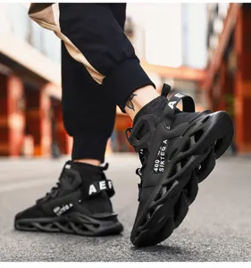 Detailed street-style view of black mesh sneaker featuring hollow blade sole and letter straps