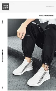 Detail view of white breathable mesh sneaker with CCJQ.XF print and thick rubber sole