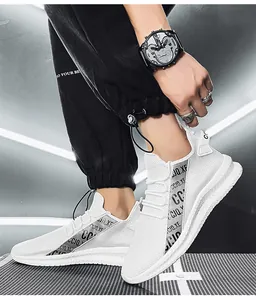Detail of white mesh sneaker with silver logo strap and chunky anti-slip sole