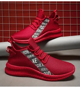 Detail of red mesh running shoe featuring white lettered side straps and sawtooth foam sole