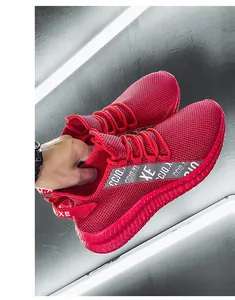 Detail of red breathable mesh running shoes with thick non-slip soles and athletic texture