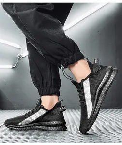 Detail of breathable mesh men's sneaker with silver reflective accents and thick grip sole