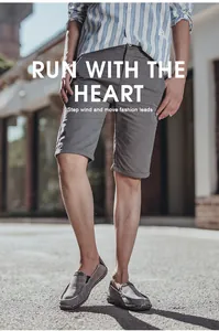 Men's retro gray canvas loafers and casual shorts in an outdoor street setting
