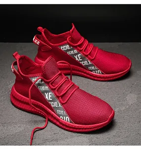 Detail of red mesh running shoes featuring breathable knit fabric and textured anti-slip soles
