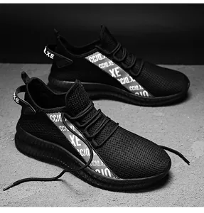 Detailed macro view of the breathable black mesh texture on men's lightweight sport shoes
