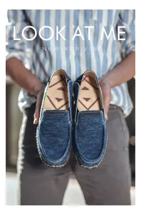 Detail of blue denim loafers with ethnic triangle pattern insoles and classic branding